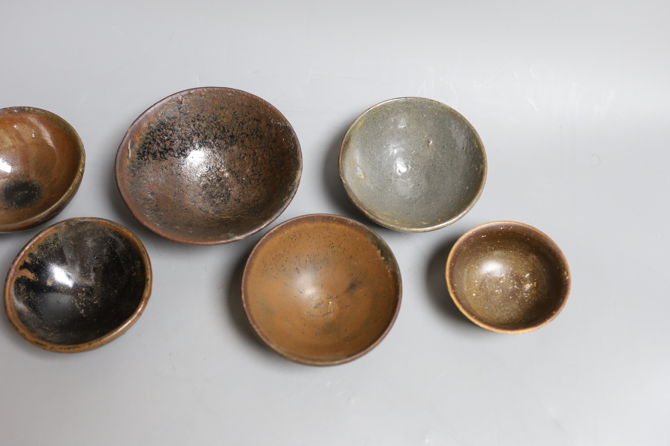 A group of Chinese Jian ware tea bowls, Song dynasty, largest 11.5 cms diameter, 7cm to 11.4cm diameter